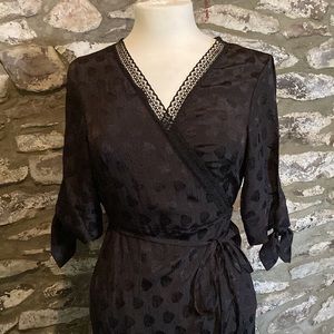 Black wrap dress size 8 NWT with open sleeve detail.